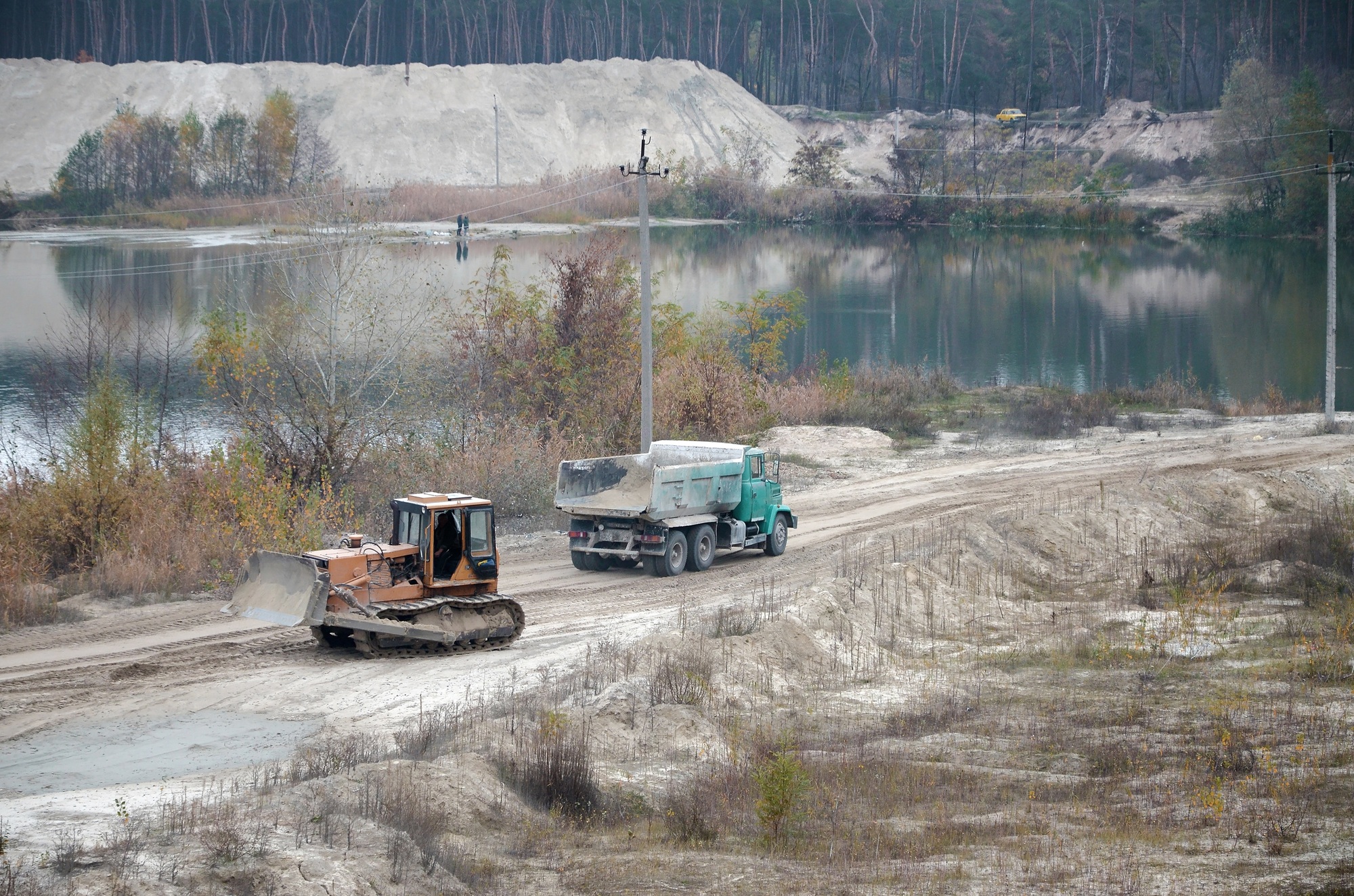 Caterpillar loader and dump truck works at the opencast mining q